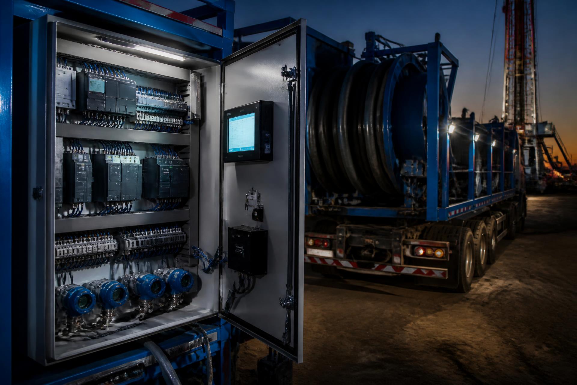 Industrial control cabinet with PLC hardware, HMI and coiled tubing service truck